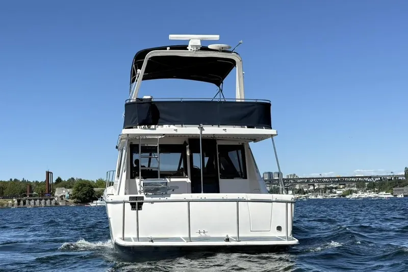 Slide: The Image of 1997 Bayliner 3988 Command Bridge Motoryacht cruising on a sunny day. - 2