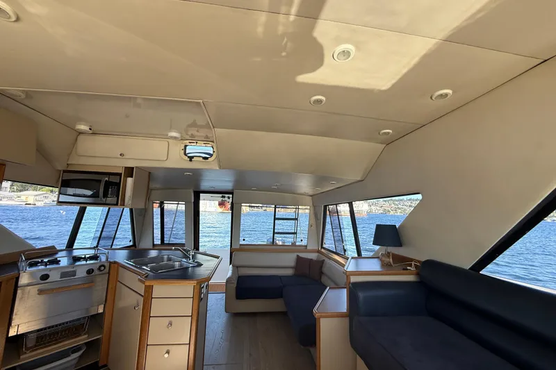 Slide: The Image of Interior of 1997 Bayliner 3988 Command Bridge Motoryacht with kitchen and seating area. - 23