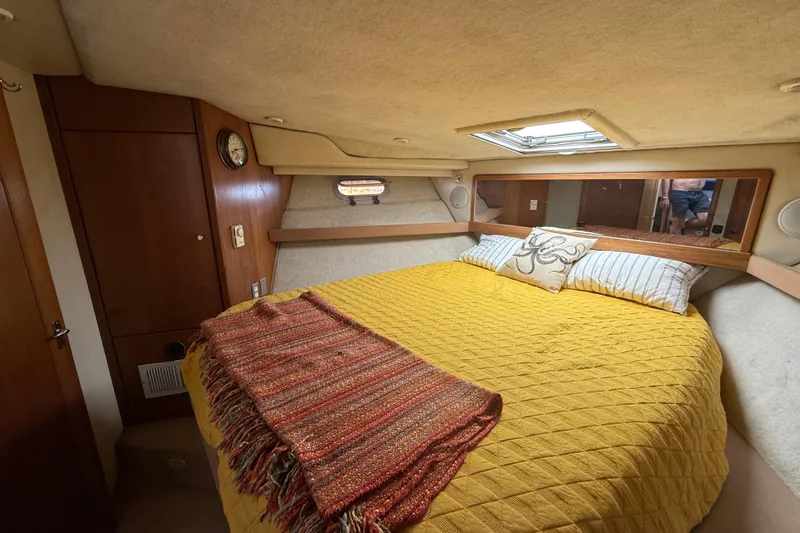 Slide: The Image of Cozy bedroom in 1997 Bayliner 3988 Command Bridge Motoryacht with yellow bedding and wood accents. - 25