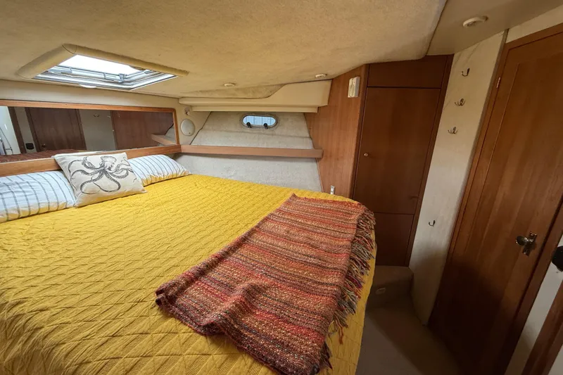 Slide: The Image of Cozy bedroom in 1997 Bayliner 3988 Command Bridge Motoryacht with yellow bedding and skylight. - 26