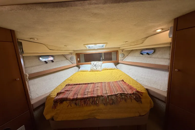 Slide: The Image of Cozy bedroom in 1997 Bayliner 3988 Command Bridge Motoryacht with yellow bedding and porthole windows. - 27