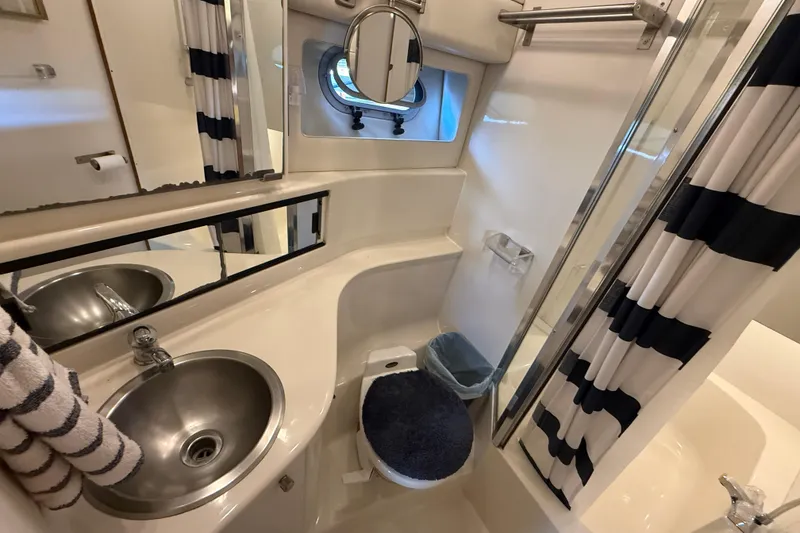 Slide: The Image of Bathroom interior of 1997 Bayliner 3988 Command Bridge Motoryacht with sink, toilet, and shower. - 29