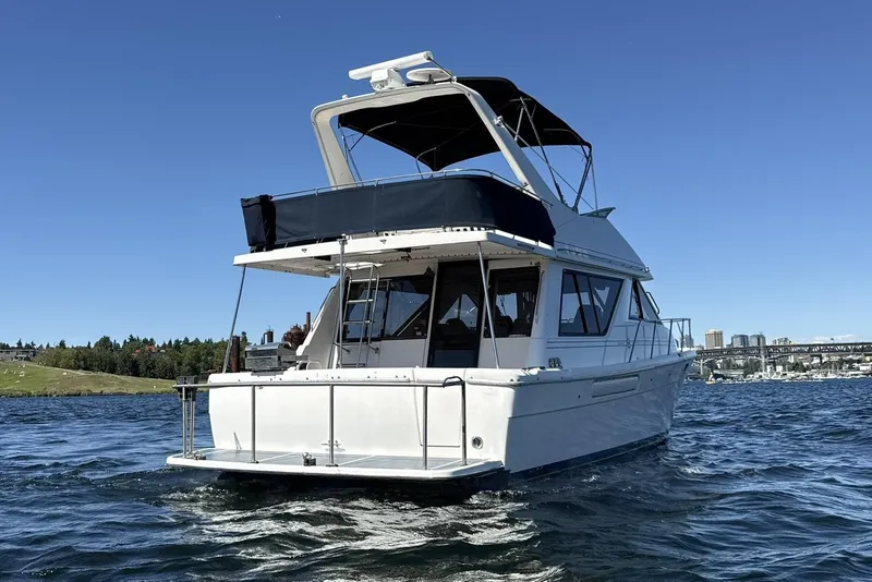 Slide: The Image of 1997 Bayliner 3988 Command Bridge Motoryacht cruising on a sunny day. - 3