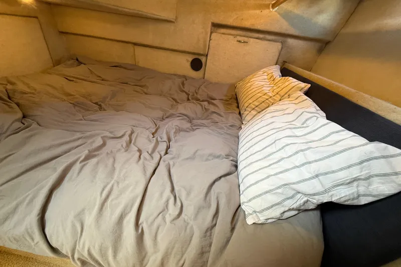 Slide: The Image of Cozy sleeping area in 1997 Bayliner 3988 Command Bridge Motoryacht with pillows and bedding. - 33