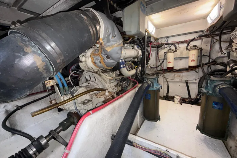 Slide: The Image of Engine room of 1997 Bayliner 3988 Command Bridge Motoryacht, showcasing mechanical components and wiring. - 37