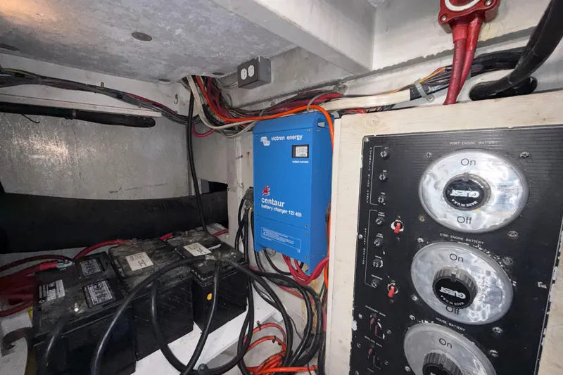 Slide: The Image of Engine room of 1997 Bayliner 3988 Command Bridge Motoryacht with battery charger and control panel. - 38