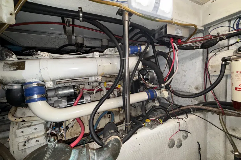 Slide: The Image of Engine room of a 1997 Bayliner 3988 Command Bridge Motoryacht, showcasing complex wiring and components. - 42