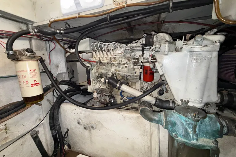 Slide: The Image of Engine compartment of a 1997 Bayliner 3988 Command Bridge Motoryacht, showcasing mechanical components. - 43