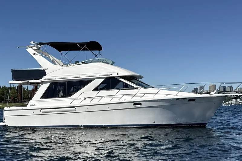 Slide: The Image of 1997 Bayliner 3988 Command Bridge Motoryacht on water, clear sky background. - 5