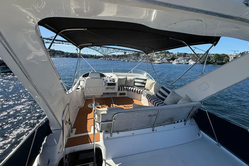 Slide: The Image of 1997 Bayliner 3988 Command Bridge Motoryacht with spacious deck and scenic waterfront view. - 8