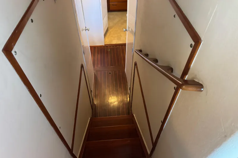 Slide: The Image of Staircase inside 1958 Blanchard Pilothouse boat with wooden handrails and flooring. - 24