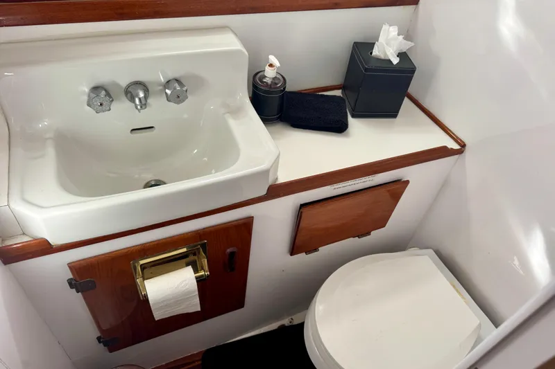 Slide: The Image of 1958 Blanchard Pilothouse bathroom with sink, toilet, and wooden accents. - 27