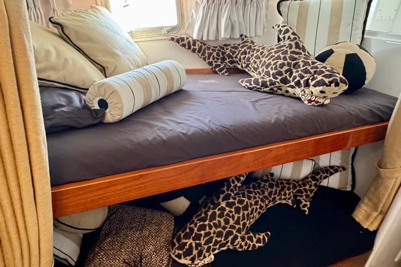 Slide: The Image of 1958 Blanchard Pilothouse interior with plush shark toys on a bunk bed. - 28