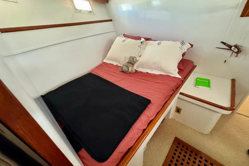 Slide: The Image of Cozy cabin interior of a 1958 Blanchard Pilothouse boat with a neatly made bed. - 30