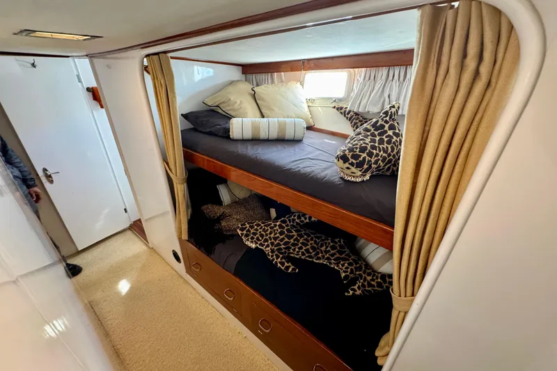 Slide: The Image of Cozy 1958 Blanchard Pilothouse cabin with bunk beds and plush shark toys. - 32