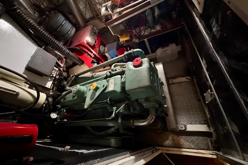 Slide: The Image of Engine room of a 1958 Blanchard Pilothouse boat, showcasing machinery and components. - 33