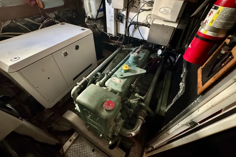 Slide: The Image of Engine room of a 1958 Blanchard Pilothouse boat, featuring machinery and equipment. - 34