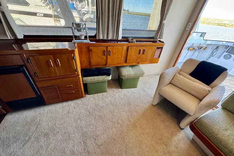 Slide: The Image of Interior of a 1958 Blanchard Pilothouse with wooden cabinetry and comfortable seating. - 38