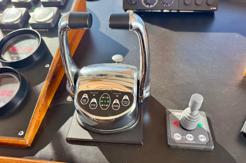 Slide: The Image of 1958 Blanchard Pilothouse controls with throttle levers and joystick on dashboard. - 42
