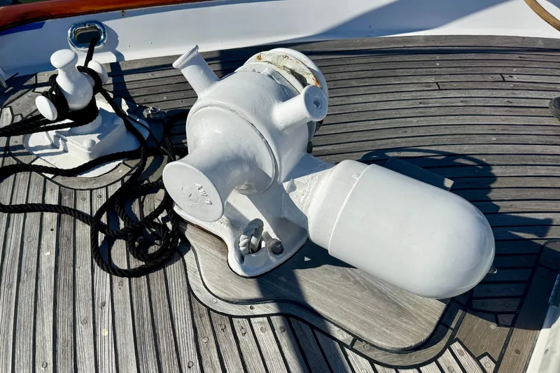 Slide: The Image of 1958 Blanchard Pilothouse deck with winch and cleat on wooden surface. - 45