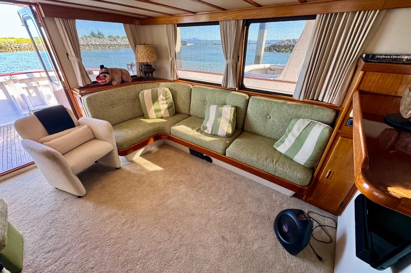 Slide: The Image of Interior of a 1958 Blanchard Pilothouse boat with cozy seating and scenic views. - 15