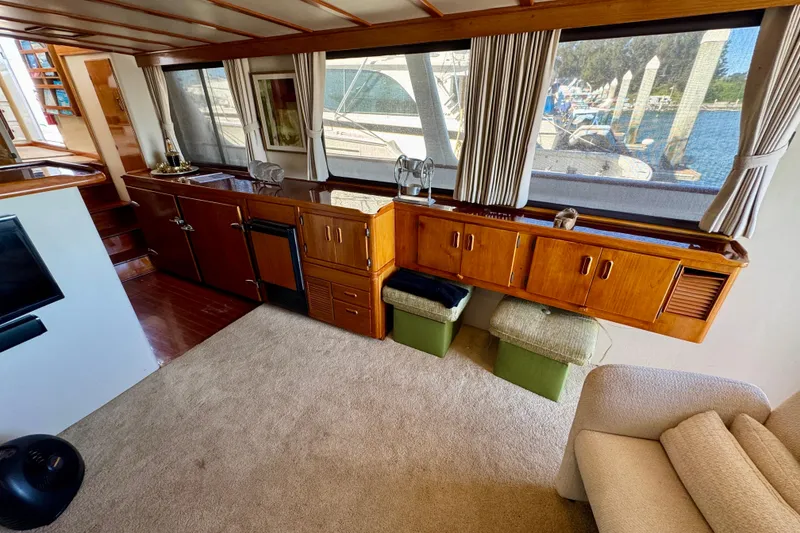 Slide: The Image of Interior of a 1958 Blanchard Pilothouse boat with wooden cabinetry and large windows. - 17