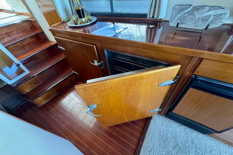 Slide: The Image of 1958 Blanchard Pilothouse interior with wooden cabinetry and open storage compartment. - 18
