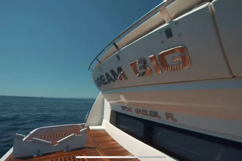Slide: The Image of 2013 Prestige 550 S yacht with "Dream Big" lettering, Coral Gables, FL, on open sea. - 12