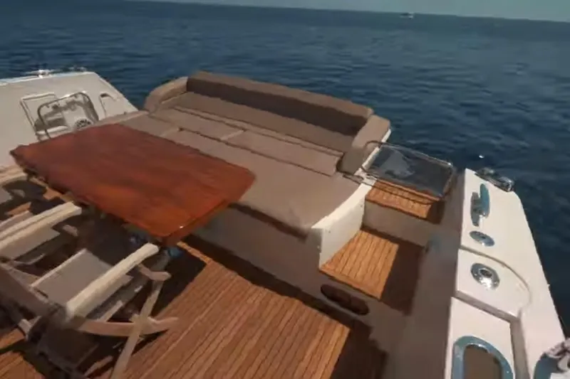 Slide: The Image of Luxury 2013 Prestige 550 S yacht deck with seating and table, overlooking the ocean. - 13