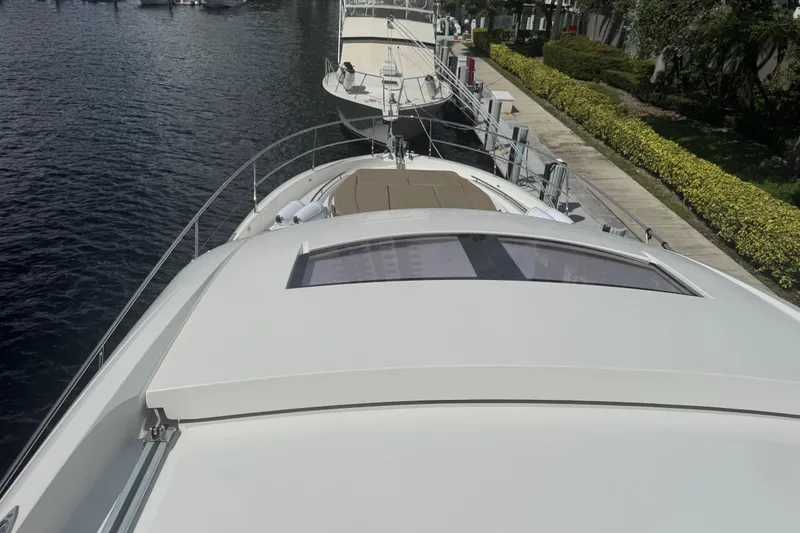 Slide: The Image of 2013 Prestige 550 S yacht docked, showcasing sleek design and spacious deck. - 16