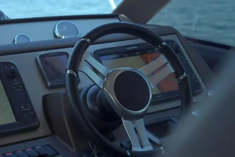 Slide: The Image of Steering wheel and dashboard of 2013 Prestige 550 S yacht, featuring navigation screens. - 30
