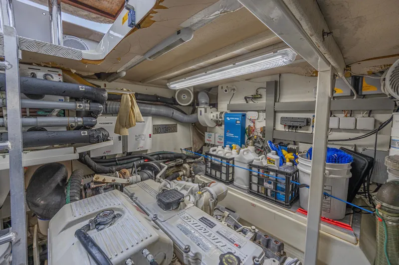 Slide: The Image of Engine room of a 2013 Prestige 550 S yacht, featuring organized equipment and storage. - 49