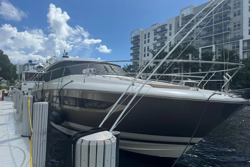 Slide: The Image of Luxury 2013 Prestige 550 S yacht docked near modern waterfront buildings. - 58
