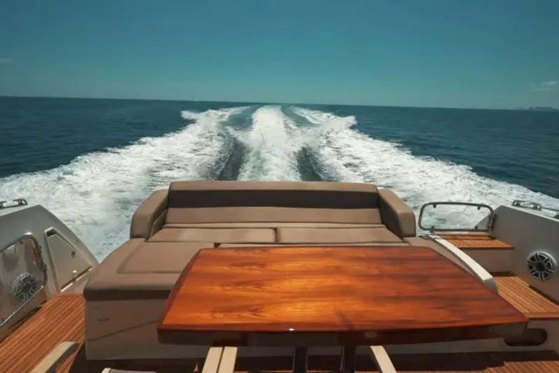 Slide: The Image of Luxury yacht Prestige 550 S cruising on open sea, 2013 model, with elegant deck seating. - 6