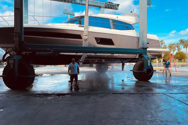 Slide: The Image of 2013 Prestige 550 S yacht lifted for maintenance at a marina. - 60