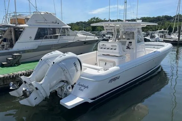The Image of 2022 Intrepid 327 Center Console boat docked with twin Yamaha engines. - 0