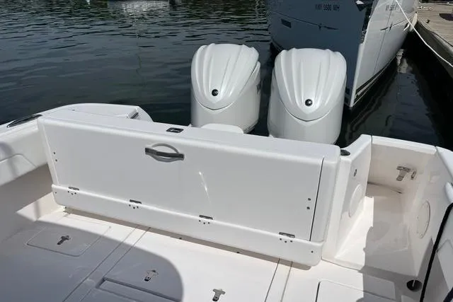 Slide: The Image of 2022 Intrepid 327 Center Console boat with dual engines docked at marina. - 12