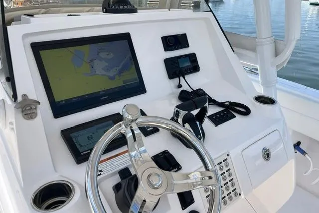 Slide: The Image of 2022 Intrepid 327 Center Console helm with navigation screens and controls. - 13