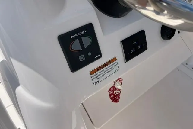 Slide: The Image of Control panel of a 2022 Intrepid 327 Center Console boat with thruster controls. - 14