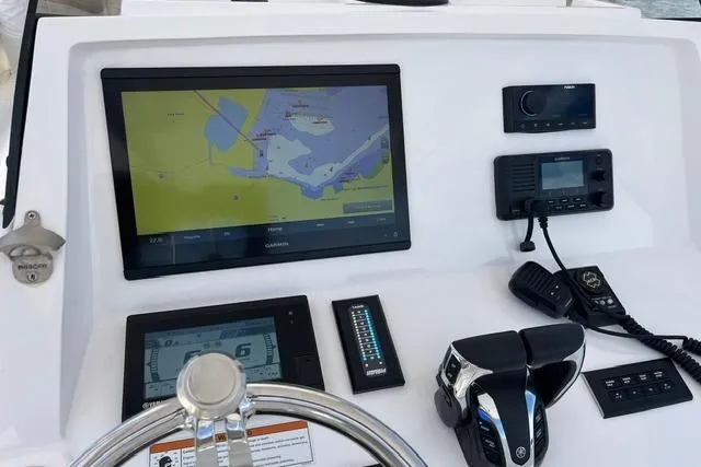 Slide: The Image of 2022 Intrepid 327 Center Console dashboard with navigation and communication equipment. - 15