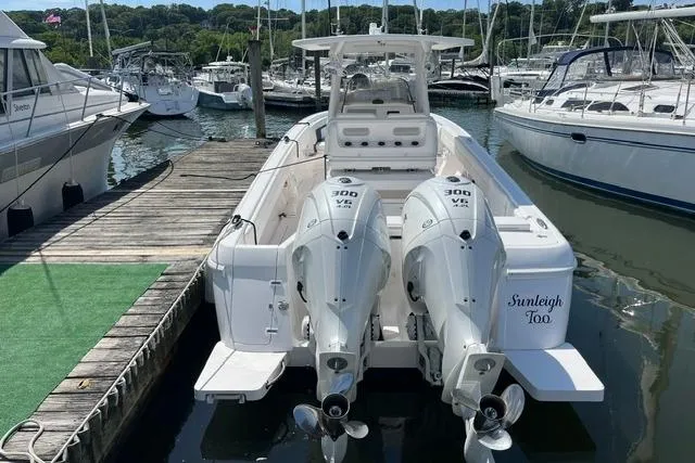 Slide: The Image of 2022 Intrepid 327 Center Console boat docked with twin 300 HP engines. - 16