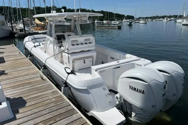 Slide: The Image of 2022 Intrepid 327 Center Console boat docked with twin Yamaha engines. - 17