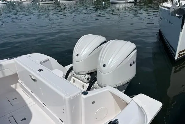 Slide: The Image of 2022 Intrepid 327 Center Console with twin Yamaha outboard engines docked in marina. - 3
