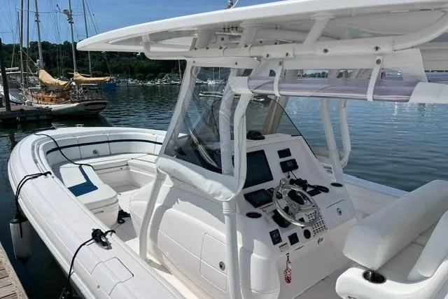 Slide: The Image of 2022 Intrepid 327 Center Console boat docked, featuring sleek design and modern controls. - 4