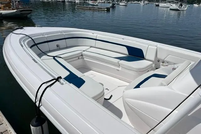 Slide: The Image of 2022 Intrepid 327 Center Console boat with spacious seating, docked in a marina. - 5