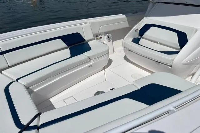 Slide: The Image of 2022 Intrepid 327 Center Console boat interior with white and blue seating. - 8