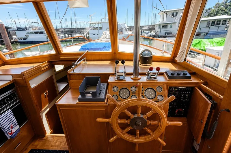 Slide: The Image of Helm of 1989 Grand Banks 42 Classic yacht with wooden wheel and navigation instruments. - 15