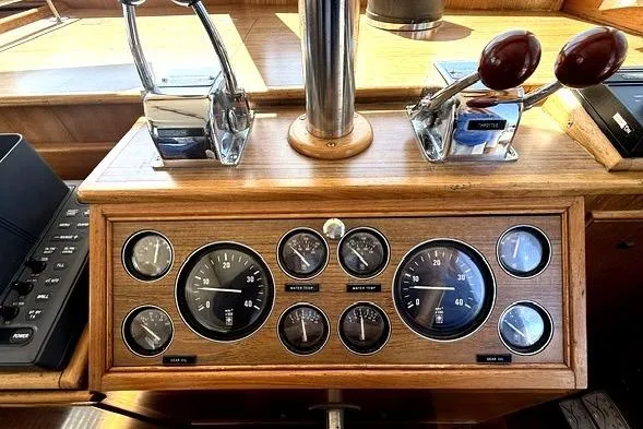 Slide: The Image of Dashboard of a 1989 Grand Banks 42 Classic boat with gauges and controls. - 16
