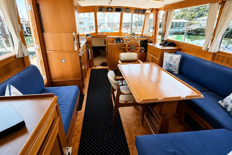 Slide: The Image of Interior of 1989 Grand Banks 42 Classic yacht with wooden furnishings and blue seating. - 30