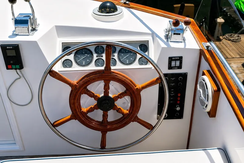 Slide: The Image of Helm of 1989 Grand Banks 42 Classic yacht with wooden wheel and navigation instruments. - 7